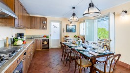 Luxury Villa La Dolce in Santa Maria Rezzonico for Rent | Kitchen and the table